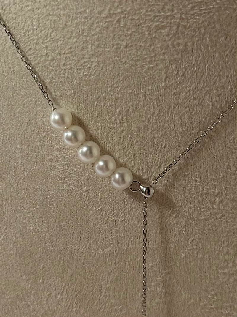 Close-up of teardrop shaped pendant with 6 freshwater pearls graduated size 9-10mm and 4-5mm 925 silver setting